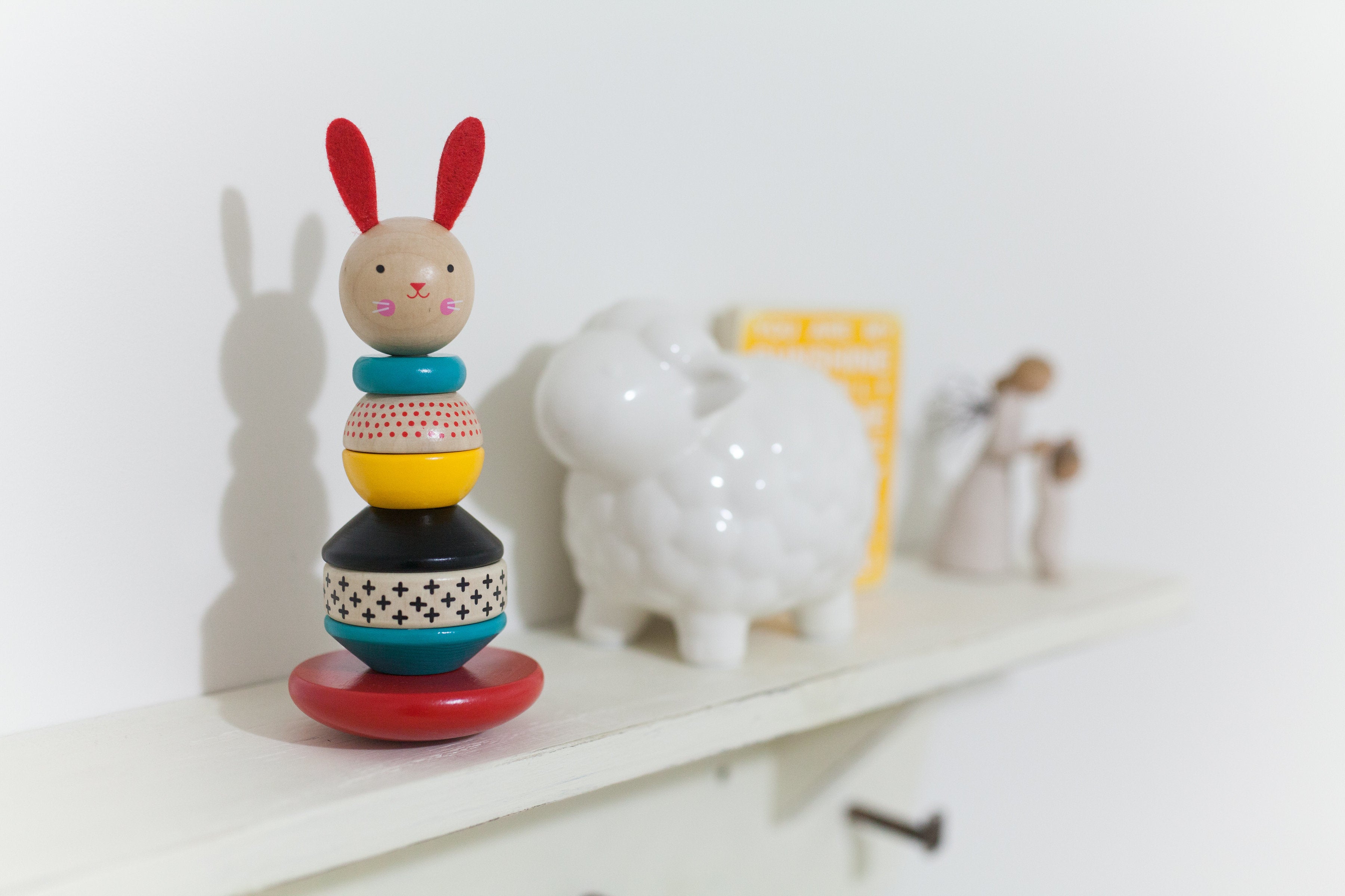 babys-toys-on-shelf, wooden toys rabbit, and a sheep